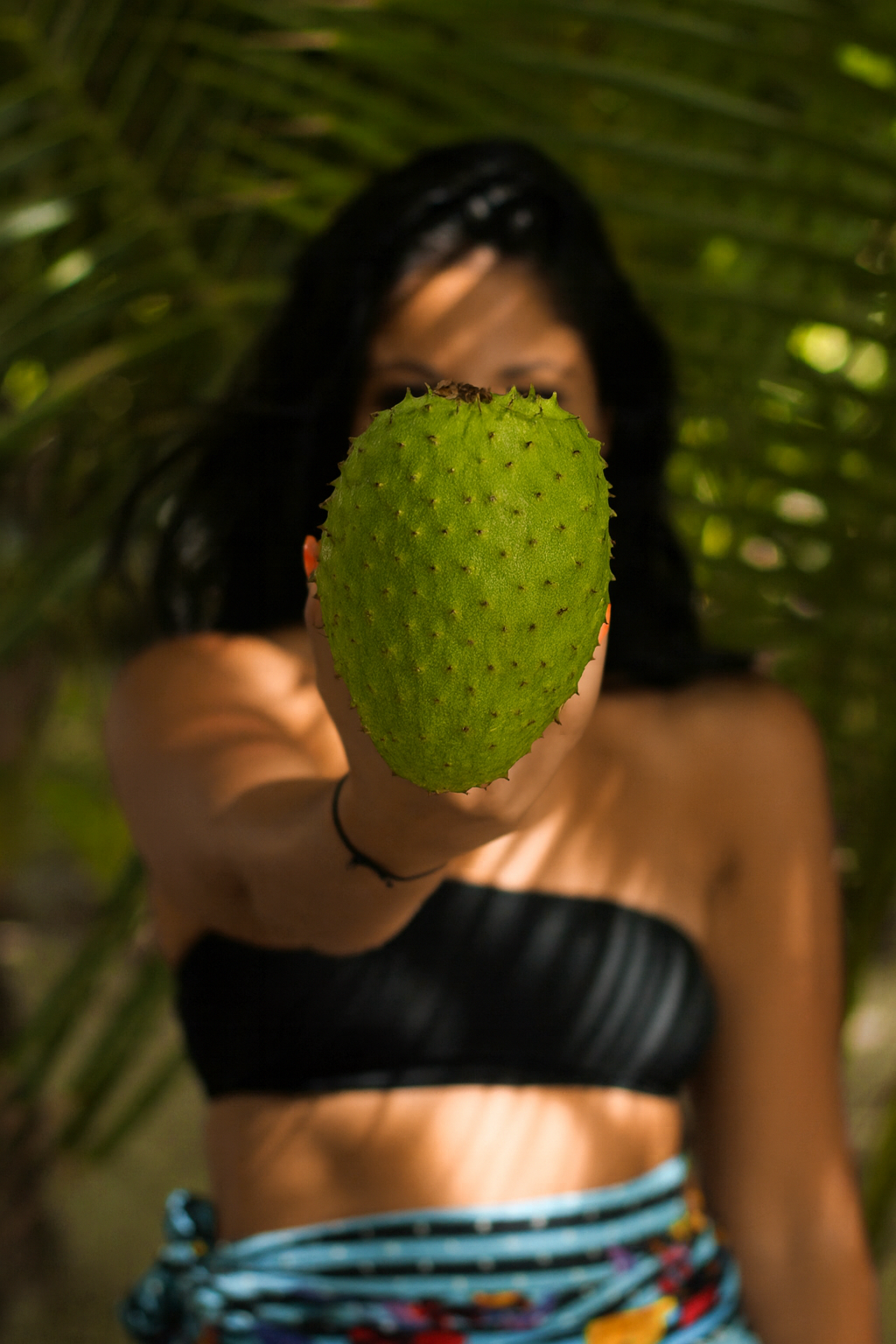 Forceup 100% Natural Soursop Oil in a clear bottle with a green label and fresh soursop fruit in the background.